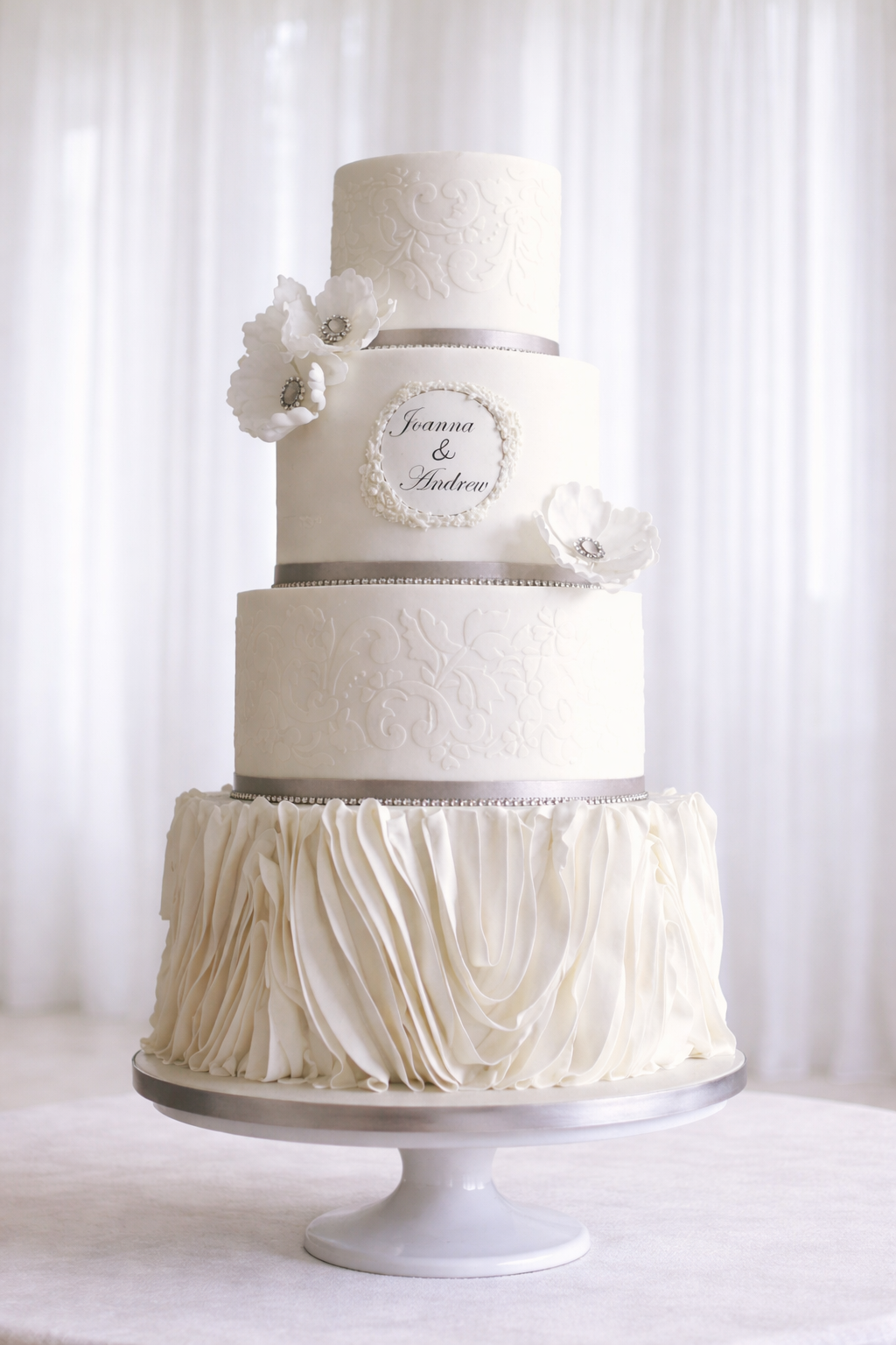 Four tier white ruffles lace wedding cake, Essex